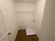 Inside the laundry room, featuring wood-look floors and a wire shelf at 2013 Reserve Pkwy, Mcdonough, GA 30253