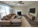 Modern living room with a large sectional sofa, fireplace, and a wall-mounted television at 2013 Reserve Pkwy, Mcdonough, GA 30253