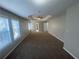 Spacious primary bedroom with tray ceilings, ceiling fan, and natural light at 2013 Reserve Pkwy, Mcdonough, GA 30253