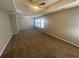 Spacious primary bedroom with tray ceilings, ceiling fan, and natural light at 2013 Reserve Pkwy, Mcdonough, GA 30253