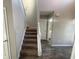 A carpeted staircase with white banisters leading to the upper level of the home at 2013 Reserve Pkwy, Mcdonough, GA 30253