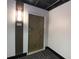 Apartment door with light fixture featuring a dark accent wall and stylish carpet at 265 18Th Nw St # 2329, Atlanta, GA 30363