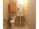 Neutral bathroom featuring a pedestal sink, toilet, mirrored cabinet, and tiled floor at 265 18Th Nw St # 2329, Atlanta, GA 30363