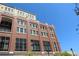 Stately brick building with many windows, topped with tan stone accent trim at 265 18Th Nw St # 2329, Atlanta, GA 30363