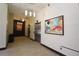 Hallway view featuring neutral color palette, decorative lighting, stainless steel elevator, and modern art at 265 18Th Nw St # 2329, Atlanta, GA 30363
