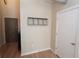 View of the hallway leading to a bedroom, with a coat rack and wooden floors at 265 18Th Nw St # 2329, Atlanta, GA 30363