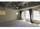 Comfortable loft featuring a ceiling fan and three windows dressed with long curtains, adding natural light and style at 265 18Th Nw St # 2329, Atlanta, GA 30363