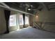 Comfortable loft featuring a ceiling fan and three windows dressed with long curtains, adding natural light and style at 265 18Th Nw St # 2329, Atlanta, GA 30363
