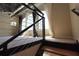 Modern loft staircase featuring metal railing and views of large bright windows at 265 18Th Nw St # 2329, Atlanta, GA 30363