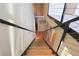 Stairway featuring wood steps and a metal cable railing, offering a sleek and modern design at 265 18Th Nw St # 2329, Atlanta, GA 30363