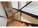 Stairway featuring wood steps and a metal cable railing, offering a sleek and modern design at 265 18Th Nw St # 2329, Atlanta, GA 30363
