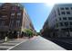 Street view of buildings with sidewalks and crosswalks surrounded by commercial properties with a blue sky overhead at 265 18Th Nw St # 2329, Atlanta, GA 30363