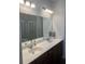 Bathroom features a double vanity with large mirror and modern lighting fixtures at 2660 Bateman Sw St, Powder Springs, GA 30127
