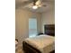 Neutral bedroom featuring a wood headboard, window, and neutral carpet at 2660 Bateman Sw St, Powder Springs, GA 30127