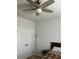 Cozy bedroom featuring a ceiling fan, white doors, and a comfortable bed with a patterned quilt at 2660 Bateman Sw St, Powder Springs, GA 30127