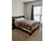 Bedroom with a bed, carpet and window covered by blinds and curtains at 2660 Bateman Sw St, Powder Springs, GA 30127