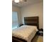 Bedroom featuring a wood headboard, window, and neutral carpet. Simple elegance! at 2660 Bateman Sw St, Powder Springs, GA 30127