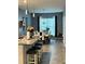 Open-concept living space showcasing a dining area with seating near a kitchen island at 2660 Bateman Sw St, Powder Springs, GA 30127