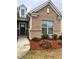 Inviting front entrance featuring a brick facade, manicured landscaping, and a stylish blue front door at 2660 Bateman Sw St, Powder Springs, GA 30127