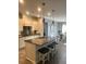 Stylish kitchen featuring a large island, stainless steel appliances, and views into the dining area at 2660 Bateman Sw St, Powder Springs, GA 30127