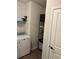 Functional laundry area with a dryer and shelving unit to maximize utility in this space at 2660 Bateman Sw St, Powder Springs, GA 30127