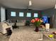 Living room with large sofa, three windows and view into kitchen with a kitchen island at 2660 Bateman Sw St, Powder Springs, GA 30127