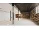 Bright basement with wood accent walls, exposed ceiling and metal support beams at 2875 Oldknow Nw Dr, Atlanta, GA 30318