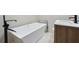 Modern bathroom with white freestanding tub and sleek black fixtures at 2875 Oldknow Nw Dr, Atlanta, GA 30318