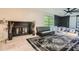 Comfortable bedroom featuring a fireplace, ceiling fan, and ample natural light at 2875 Oldknow Nw Dr, Atlanta, GA 30318