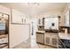 Traditional kitchen design features a stainless steel dishwasher, white cabinets, stone countertops, and tile backsplash at 2875 Oldknow Nw Dr, Atlanta, GA 30318