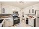 This bright kitchen is equipped with stainless steel appliances and white cabinets at 2875 Oldknow Nw Dr, Atlanta, GA 30318