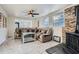 Comfortable living area featuring a ceiling fan, stacked stone accent wall, and tiled floor at 2875 Oldknow Nw Dr, Atlanta, GA 30318