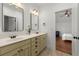 Elegant bathroom with double vanity, decorative mirrors, and a view into the bedroom at 3180 Ashton Old Rd, Douglasville, GA 30135
