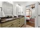 Bathroom featuring granite countertop, double sinks, and white cabinetry at 3180 Ashton Old Rd, Douglasville, GA 30135