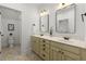 Stylish bathroom with a double vanity, warm lighting, and beige tiled flooring at 3180 Ashton Old Rd, Douglasville, GA 30135
