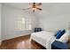 Bedroom with hardwood floors, a ceiling fan, and natural light through the shutters at 3180 Ashton Old Rd, Douglasville, GA 30135