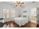 Cozy bedroom with natural light, hardwood floors, a ceiling fan, and ensuite bathroom at 3180 Ashton Old Rd, Douglasville, GA 30135