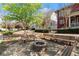 Community outdoor fire pit surrounded by benches and lush landscaping at 3180 Ashton Old Rd, Douglasville, GA 30135