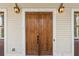 Elegant wooden double front door with stylish lighting fixtures at 3180 Ashton Old Rd, Douglasville, GA 30135