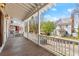 Relaxing front porch with wood flooring overlooking the landscaped front yard at 3180 Ashton Old Rd, Douglasville, GA 30135