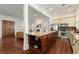 Open kitchen with granite island, stainless steel appliances, and breakfast bar, flowing into the living area at 3180 Ashton Old Rd, Douglasville, GA 30135
