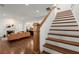Bright living room featuring hardwood floors, fireplace, and an open staircase at 3180 Ashton Old Rd, Douglasville, GA 30135
