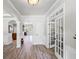 Bright foyer with hardwood floors, white trim, and decorative architectural details at 6597 River Island Dr, Buford, GA 30518