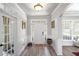 Bright foyer with hardwood floors, white trim, and a white front door with sidelights at 6597 River Island Dr, Buford, GA 30518