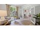 Cozy living room with a large window, patterned curtains, and French doors at 6597 River Island Dr, Buford, GA 30518