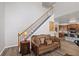 Living room features staircase, adjacent kitchen and seating area at 6597 River Island Dr, Buford, GA 30518