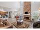 Living room featuring an open layout with fireplace, kitchen, and dining area at 6597 River Island Dr, Buford, GA 30518