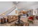 Open floor plan living room with staircase leading to the second floor and an adjacent kitchen at 6597 River Island Dr, Buford, GA 30518