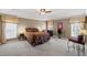 The main bedroom has neutral colors, a tray ceiling, and two bright windows allowing light into the bedroom at 6597 River Island Dr, Buford, GA 30518