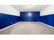 This finished basement features white and blue walls with carpeted floors at 3750 Lake Haven Way, Atlanta, GA 30349